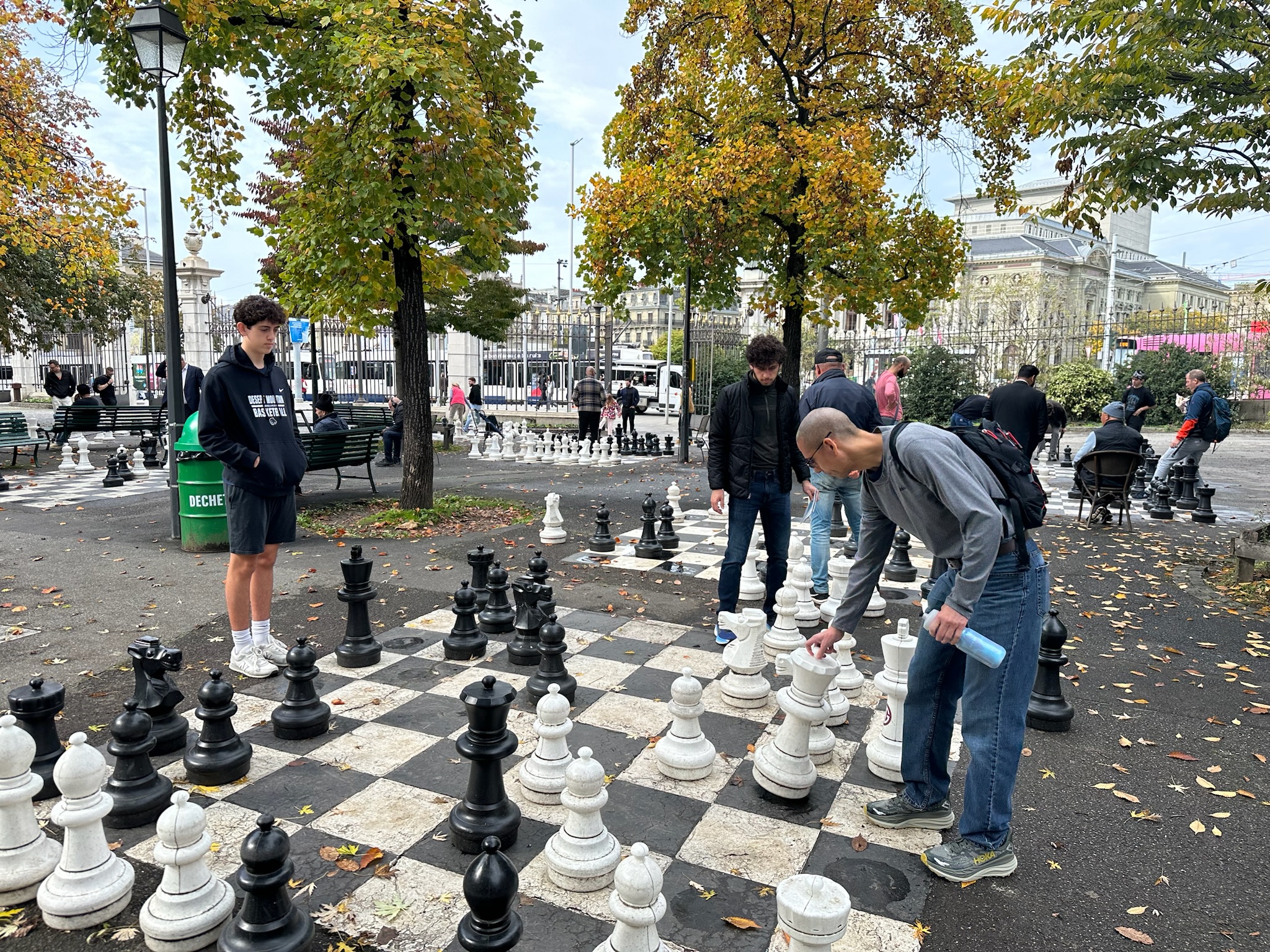 Grantham watching Camden & Baron play chess in Parc des Bastions in Geneva's Old Town